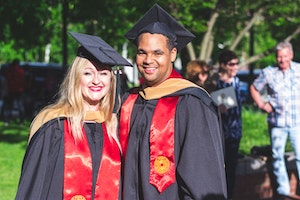 photo of woman and man in graduation regalia