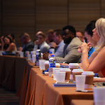 Photo by Antonio Jamal Roberson of people sitting at conference session in classroom style seating